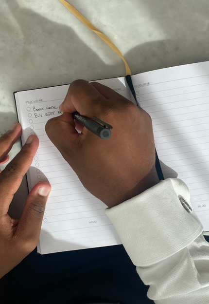 Man writing in the productivity notebook to-do list