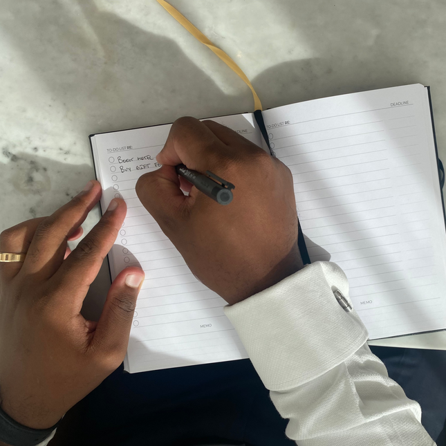 Man writing in the productivity notebook to-do list